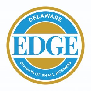 EDGE grant logo. It is circular and the outer ring is gold. In the center, is the word EDGE in blue. Two inner circles are broken up by the word edge. One in blue - the bottom  half says Division of Small Business. The inner one is gold and solid.